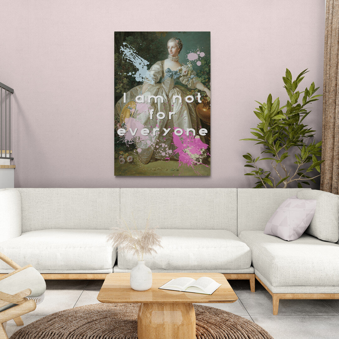 Lifestyle image of the cotton grade canvas wrapped canvas print featuring an altered piece of classical art. Image features the piece against a pink wall with beige sofa and wood tables. The altered piece is the original Madame Bergeret from 1766, a high society girl in a off-white voluminous dress surrounded by flowers. We have modernized the piece by adding bold and bright paint splashes in yellow, light blue, and hot pink and the phrase,” I am not for everyone"