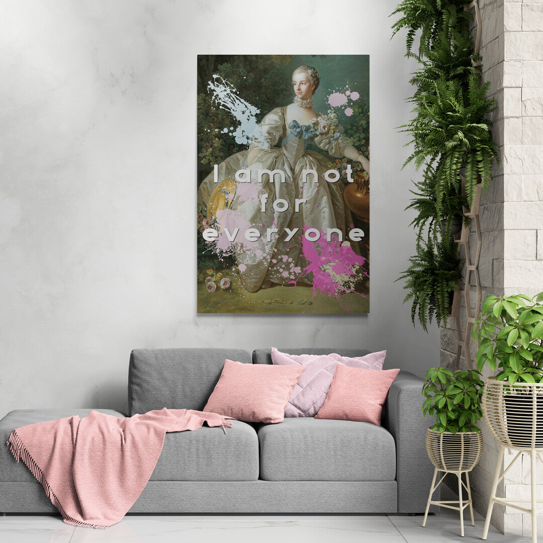 Lifestyle image of the cotton grade canvas wrapped canvas print featuring an altered piece of classical art. Image shows the piece against a gray wall with gray sofa, featuring pink pillows and throw surrounded by plants. The altered piece is the original Madame Bergeret from 1766, a high society girl in a off-white voluminous dress surrounded by flowers. We have modernized the piece by adding bold and bright paint splashes in yellow, light blue, and hot pink and the phrase,” I am not for everyone"