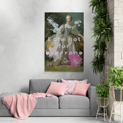 Lifestyle image of the cotton grade canvas wrapped canvas print featuring an altered piece of classical art. Image shows the piece against a gray wall with gray sofa, featuring pink pillows and throw surrounded by plants. The altered piece is the original Madame Bergeret from 1766, a high society girl in a off-white voluminous dress surrounded by flowers. We have modernized the piece by adding bold and bright paint splashes in yellow, light blue, and hot pink and the phrase,” I am not for everyone"